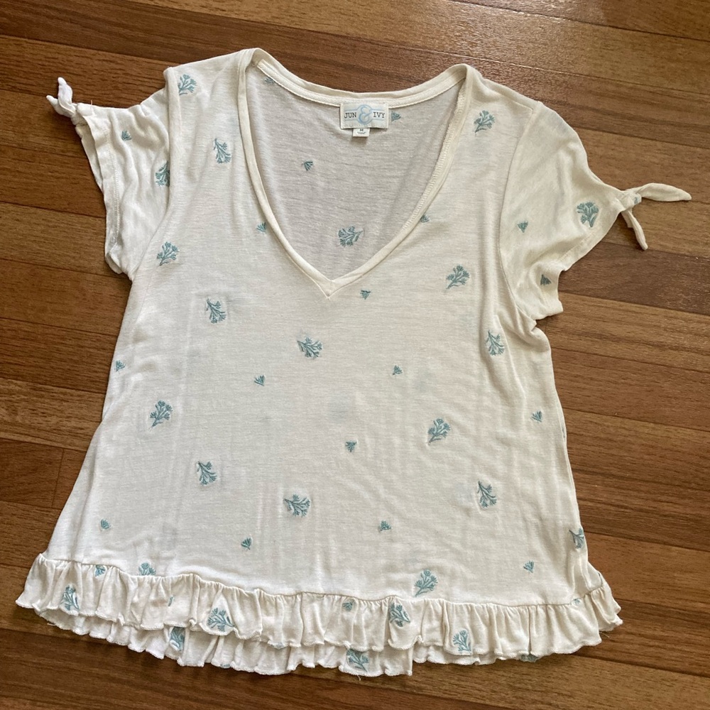 Cream with green flowers. Size medium. By jun and ivy. Ruffle at bottom.